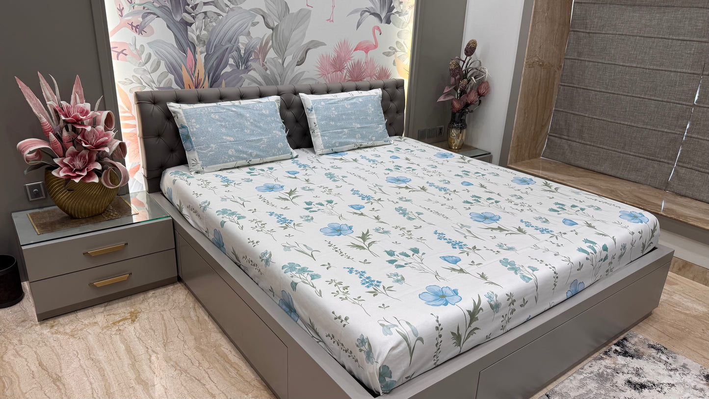 Bedroom with floral bedspread, nightstands, and decorative elements.